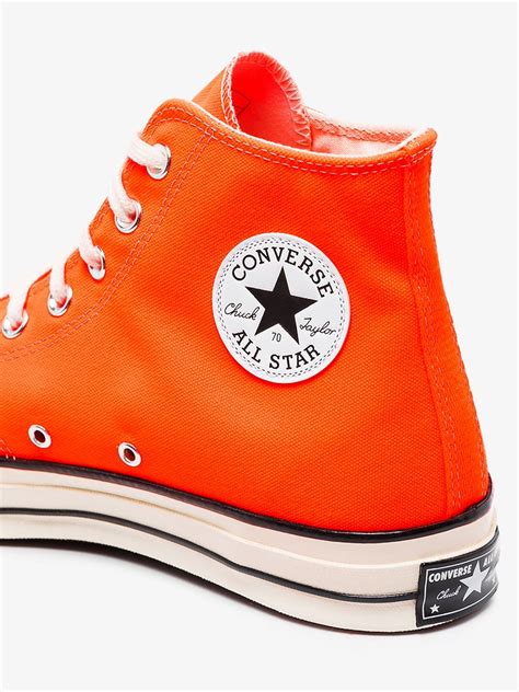 bright orange converse high tops.